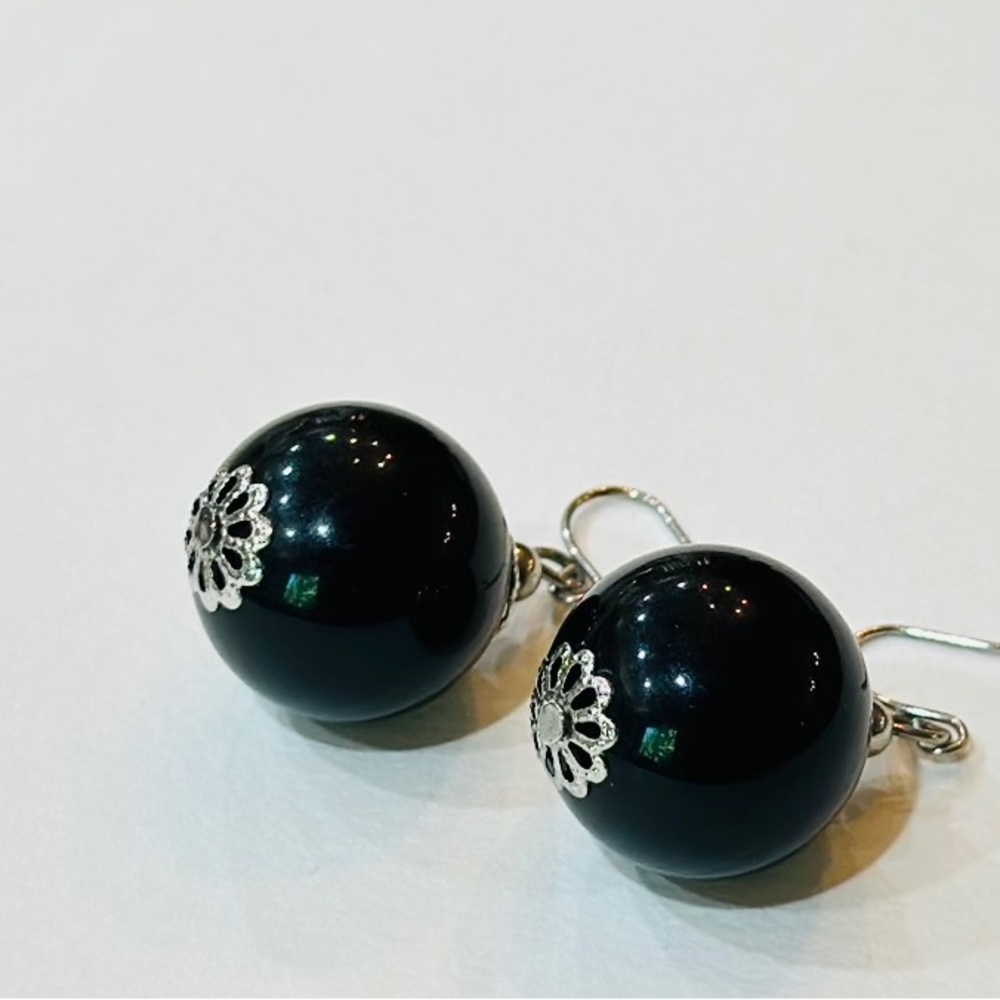 Women’s large black bead drop earrings with Silver metal accents.